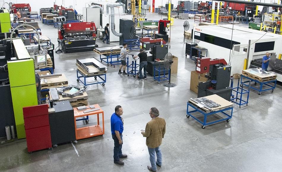 Metal fabrication production floor with workers and equipment used for OEM component review