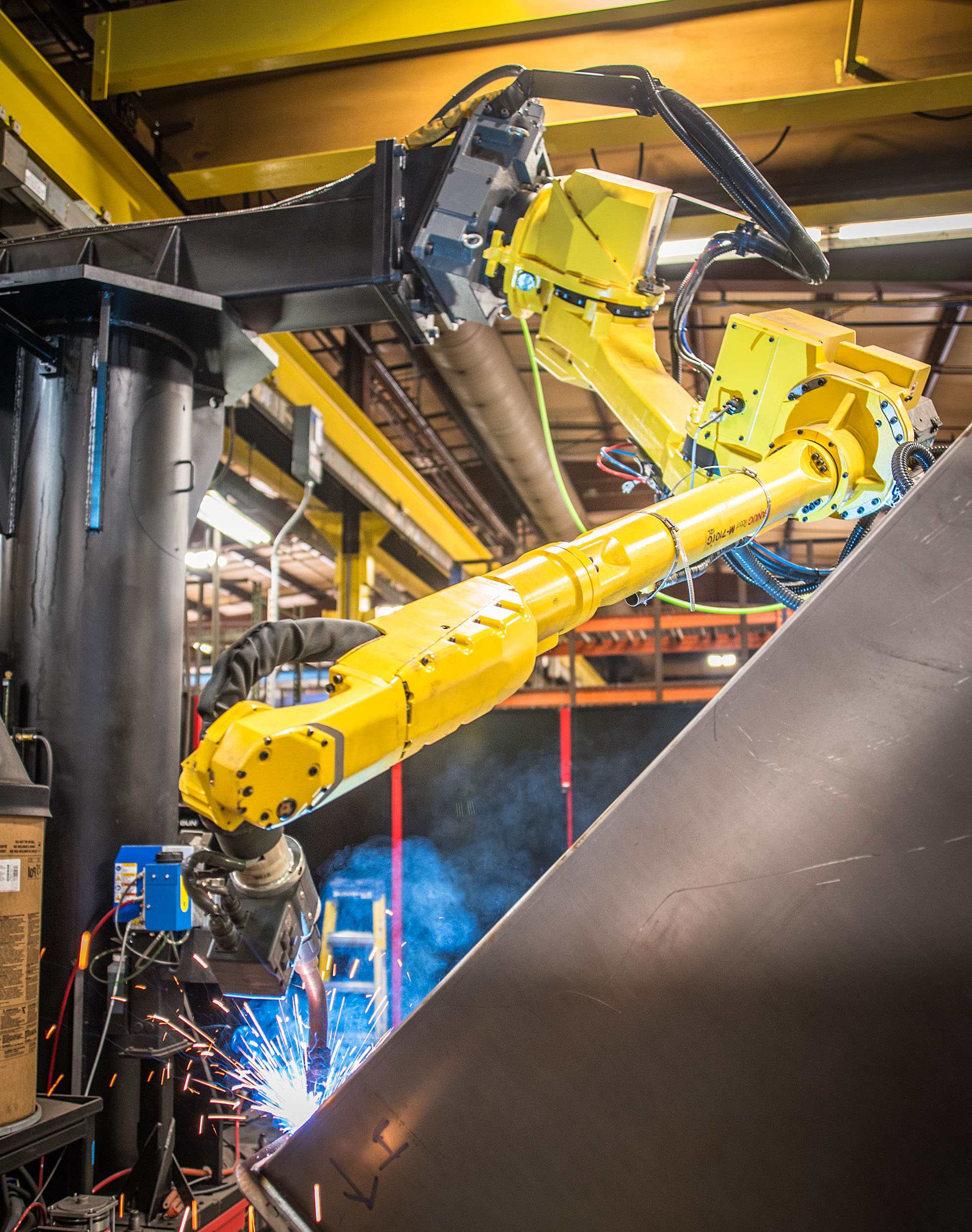 Robotic welding equipment fabricating a heavy industrial metal component