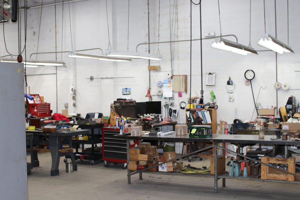 Progressive stamping die and tooling prepared in a metal manufacturing workshop
