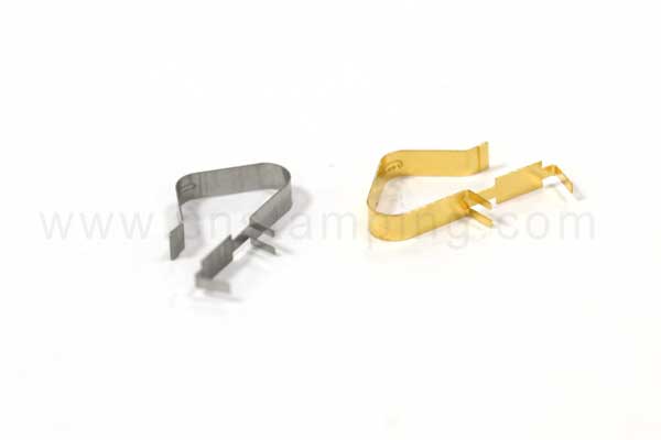 Close-up photograph of silver and gold stamped electrical spring contacts on a white background