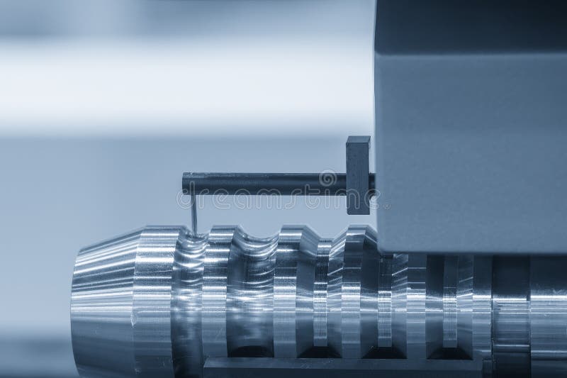 Surface roughness tester stylus measuring a turned metal shaft during machining inspection