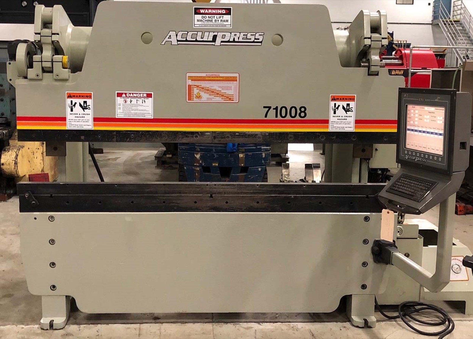 CNC press-brake tooling and formed sheet-metal setup in a fabrication workshop