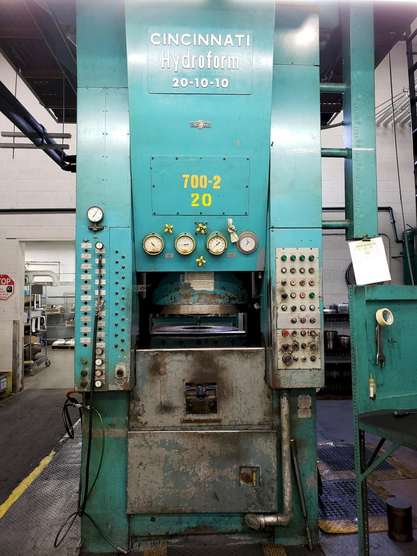 Photograph of a large turquoise Cincinnati hydroforming press with gauges and control panels