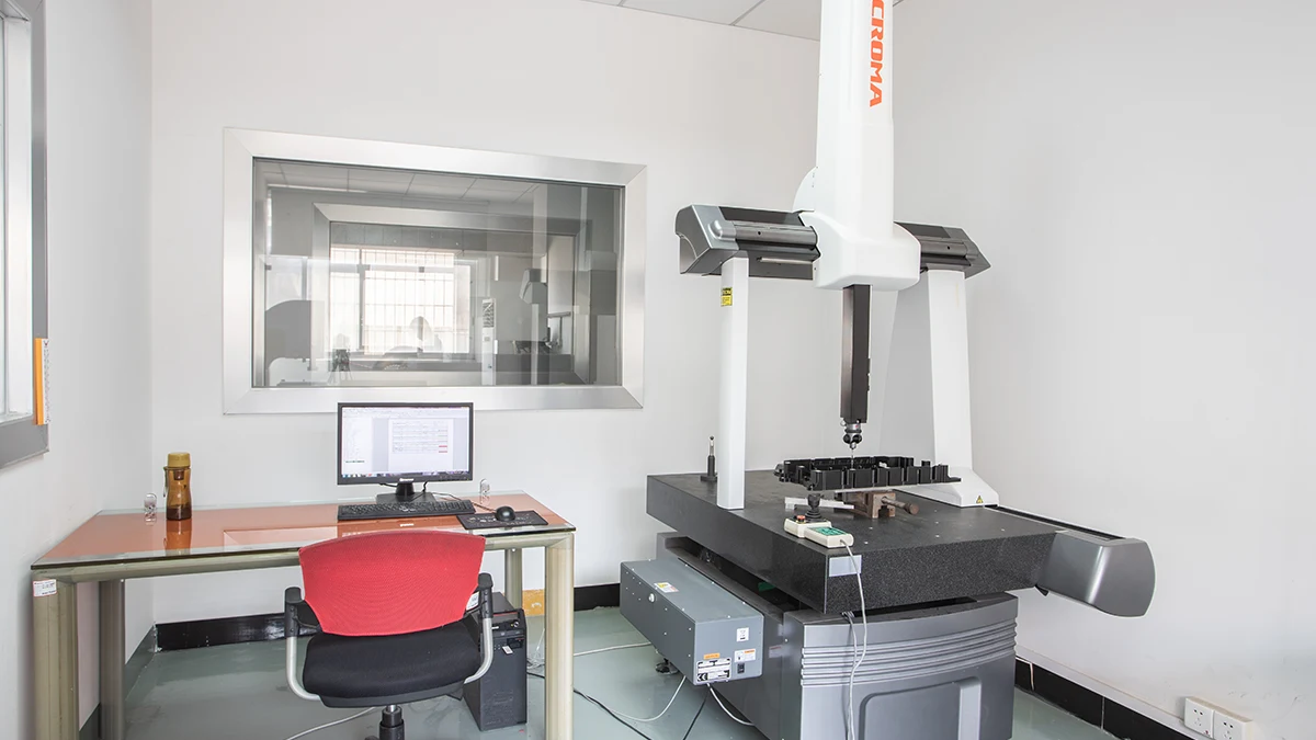 Coordinate measuring machine in a manufacturing quality-control room for inspecting precision components